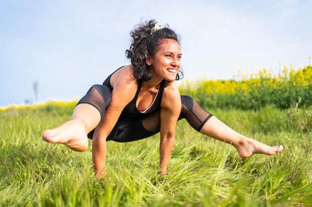 Difficult yoga exercise in the middle of nature, pilates practice