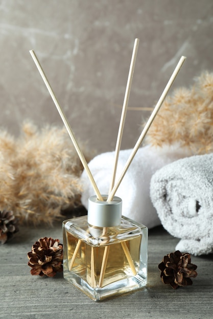 Diffuser and bath accessories on gray textured table