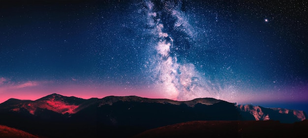 Digital art of milky way and pink light at mountains. Night colorful landscape and starry sky.