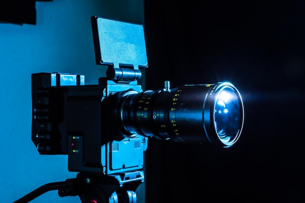 Photo digital cinema film camera in the dark video camera with copy space for film production tv or