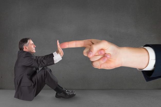 Digital composite of Big business man hand touching small business man hand