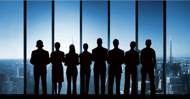 Digital composite of Business people silhouettes against building