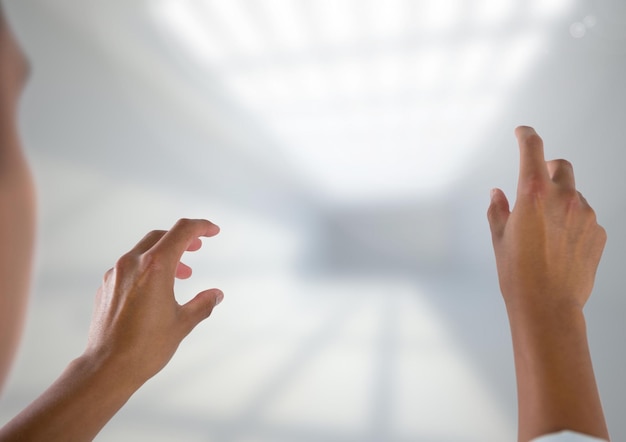 Digital composite of Hands interacting and touching air with bright background