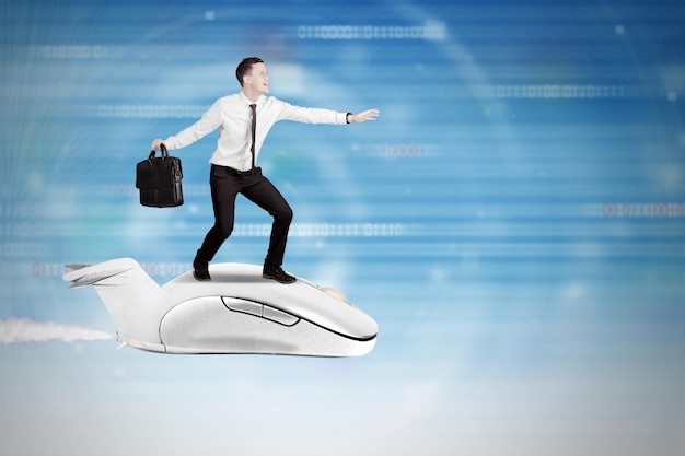 Photo digital composite image of businessman standing on computer mouse