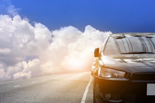 Digital composite image of cars on road against cloudy sky