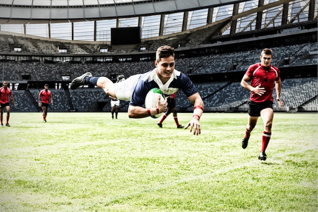 Digital composite image of rugby player jumping with the ball in sports stadium