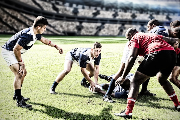 Digital composite image of team of rugby players playing rugby in sports stadium