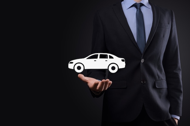 Digital composite of Man holding car icon.Car automobile insurance and car services concept. Businessman with offering gesture and icon of car