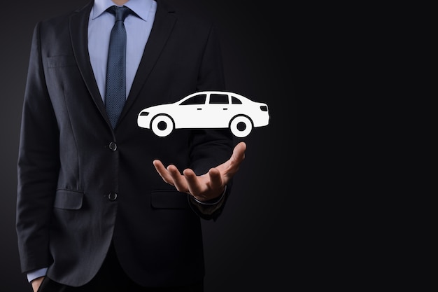 Digital composite of Man holding car icon.Car automobile insurance and car services concept. Businessman with offering gesture and icon of car