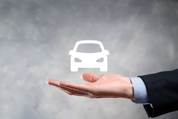 Digital composite of Man holding car symbol.Car automobile insurance and car services concept. Businessman with offering gesture and icon of car.