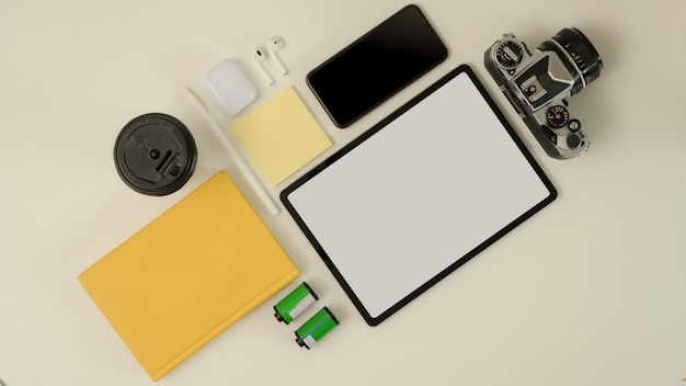 Digital devices on worktable with tablet