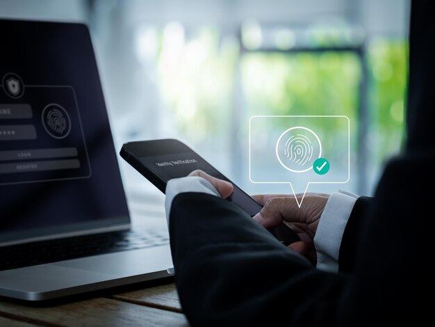 Digital finger print scan cyber security with biometrics authentication technology touch ID 2FA concepts Virtual fingerprint with checkmark icon on smart mobile phone and laptop computer