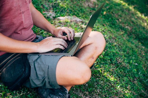 Digital nomad man working in the forest