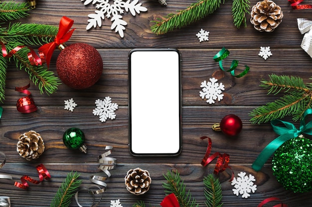 Digital phone mock up with rustic Christmas decorations for app presentation top view with empty space for you design Christmas online shopping concept Tablet with copy space on colored background