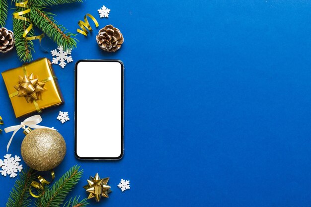 Digital phone mock up with rustic christmas decorations for app presentation top view with empty space for you design christmas online shopping concept tablet with copy space on colored background