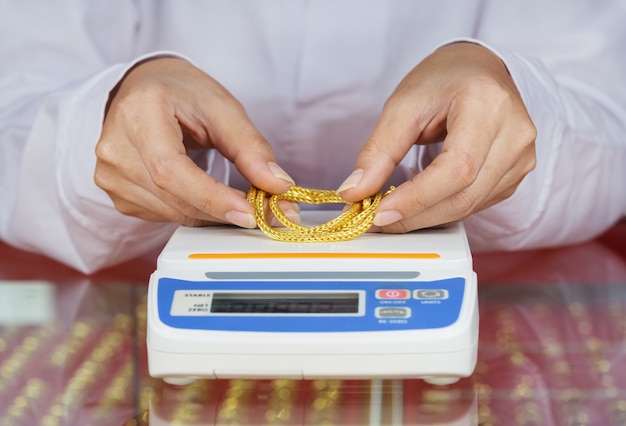 digital scales for weighing gold rings and necklaces with hand 