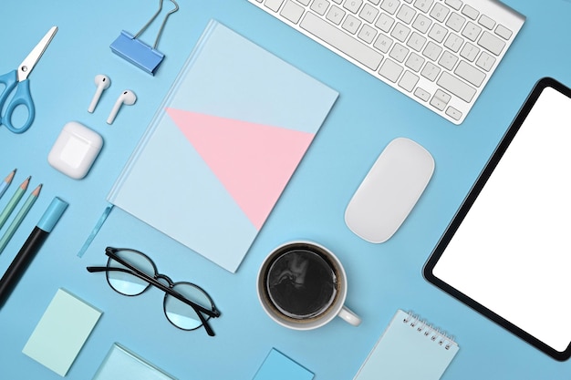 Digital tablet and blue equipment on blue background