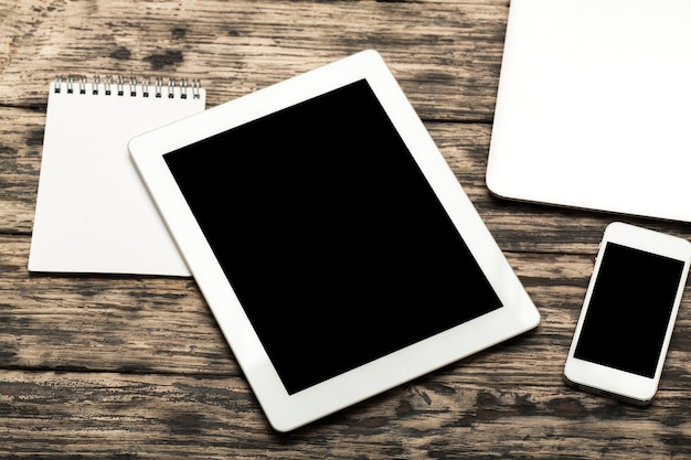 Digital tablet and phone on wooden background