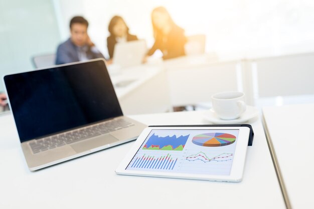 Digital tablet showing graph in meeting room