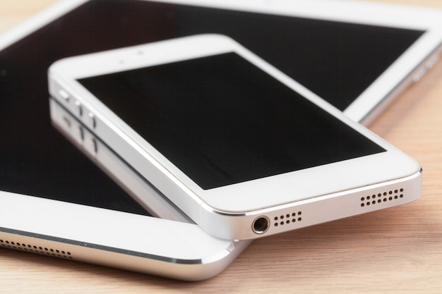 Digital tablet and smartphone on the table