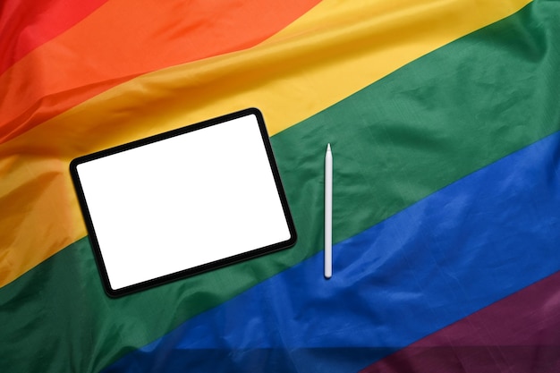 Digital tablet with blank screen on LGBT rainbow flag