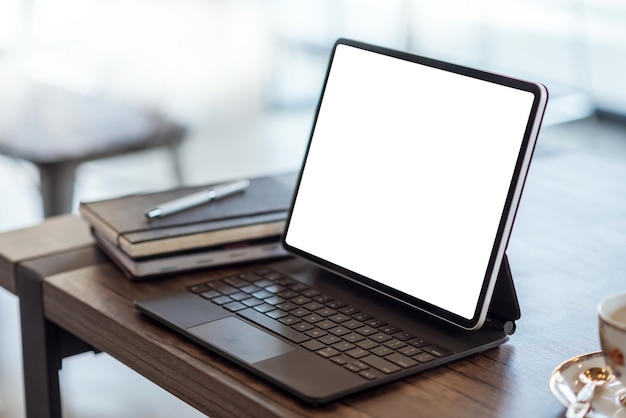 Digital tablet with blank screen on wooden table in office