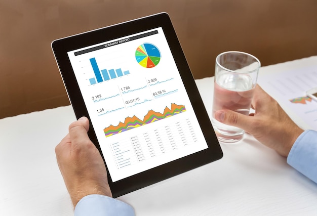 Digital tablet with chart in hands