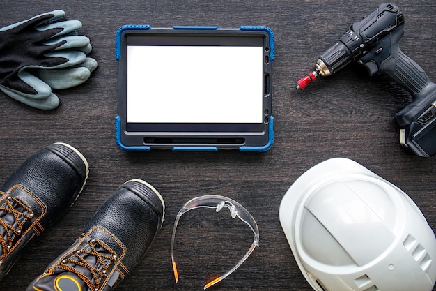 Digital tablet with layout and worker clothes top view