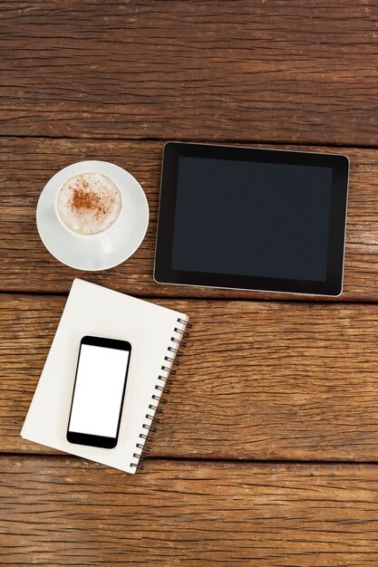 Digital tablet with smartphone and cup of coffee