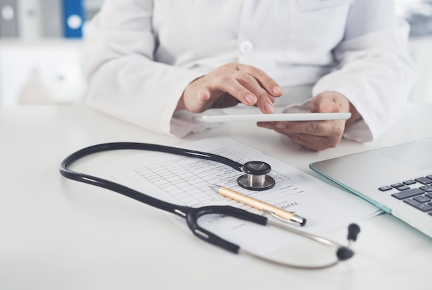 Digital tablets are recommended by doctors Cropped shot of an unrecognizable female doctor using a digital tablet while working in her office