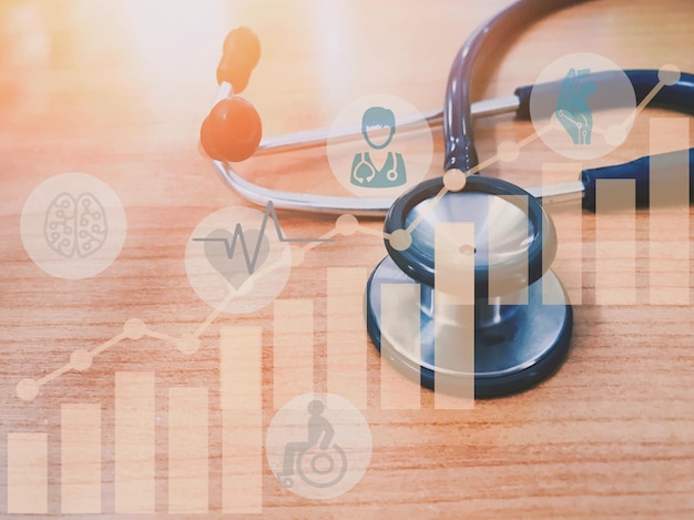 Photo digitally generated image of graphs with stethoscope on wooden table