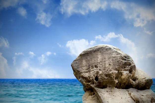 Digitally generated large rock overlooking sea and sky