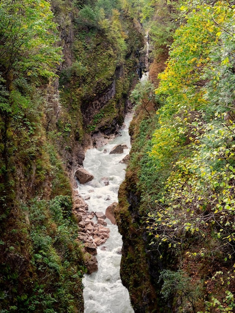 Digorskoe gorge and the Urukh River flows at breakneck speed at its bottom Narrow gap in the mountains Top view