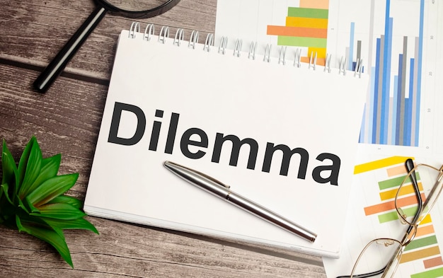 DILEMMA words on notepad and charts concept