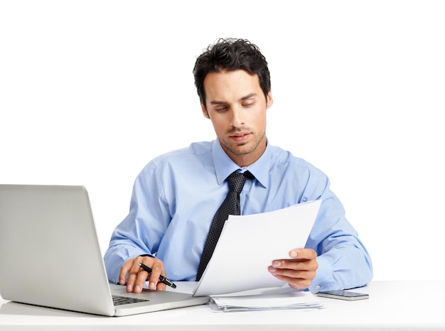 Diligence always pays off in the workplace Studio shot of a handsome businessman working on his laptop