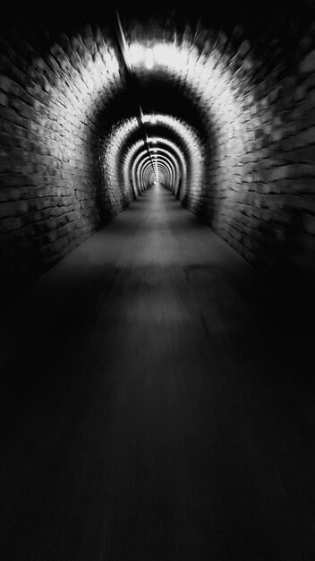 Photo diminishing perspective of illuminated tunnel