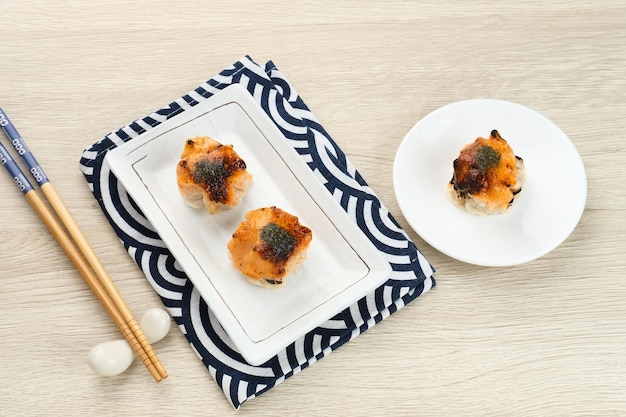 Dimsum with Japanese Mentai Sauce. Served on plate.