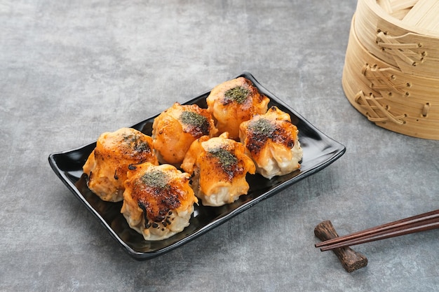 Dimsum with Japanese Mentai Sauce. Served on plate.