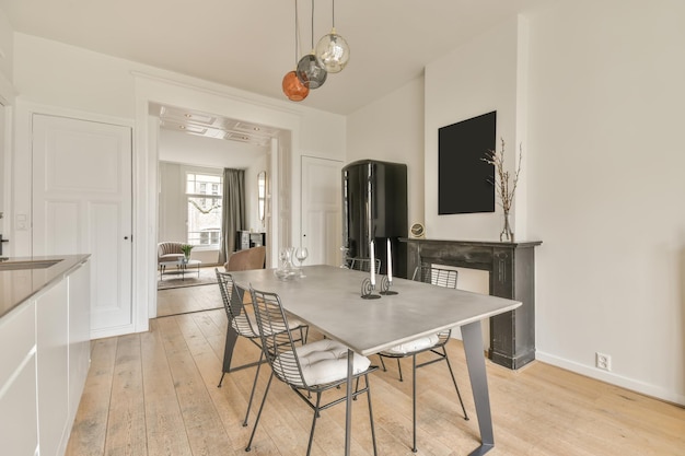 Dining area with metal furniture next to a decorative fireplace