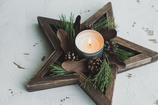 Dining place decorated with pine cones, branches and golden christmas decorations 