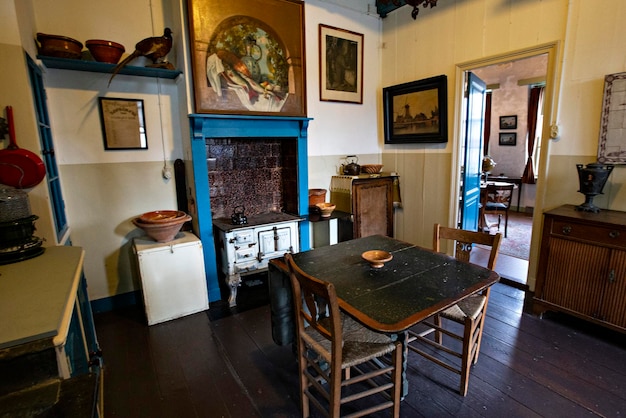 A dining room with a blue table and chairs