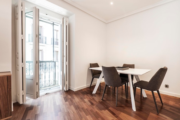 Dining room with white wooden table with vintage bay window balcony a mahogany oak parquet flooringd