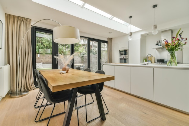 A dining room with a wooden table and black chairs