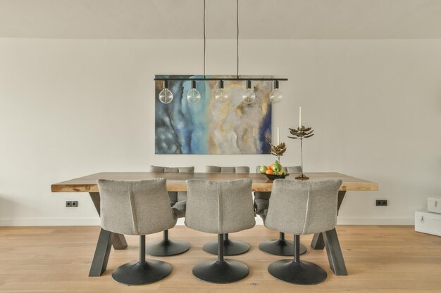 A dining room with a wooden table and chairs