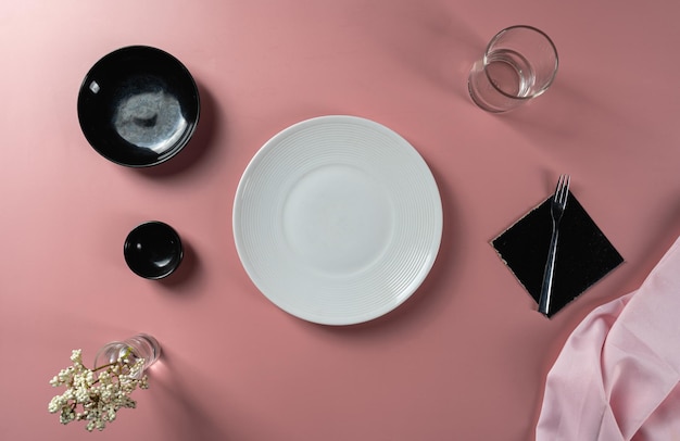 Dining set up with empty plate set placed with a knife and fork ready for food menu