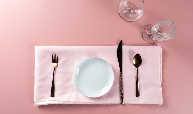 Dining set up with empty plate set placed with a knife and fork ready for food menu