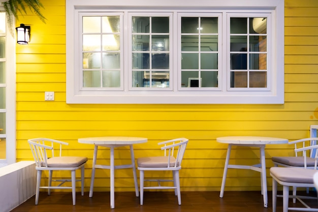 Dining table chairs and windows wooden vintage design in yellow white color