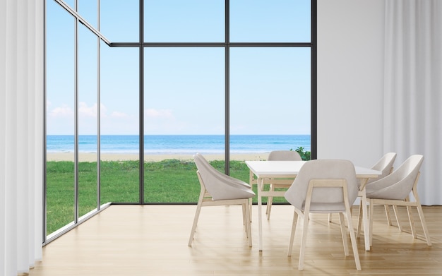 Tavolo da pranzo sul pavimento della grande sala da pranzo in una casa moderna o in un hotel di lusso con cielo e mare