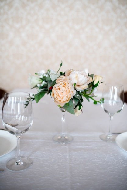 Dining table setting decorated with flowers.