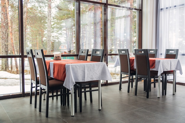 Dining tables and chairs in the restaurant. Light interior